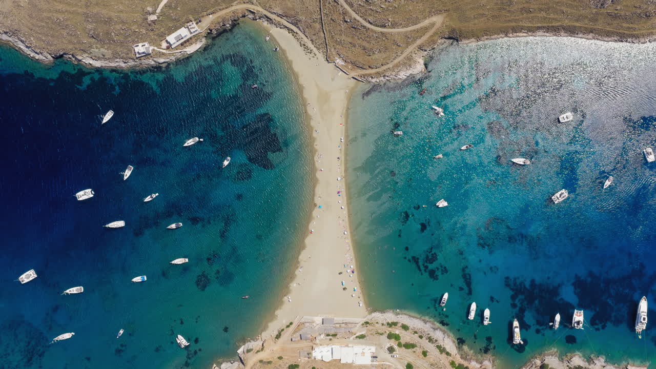 Yachts and boats moor on Kolona beach on Kythnos island, Cyclades, Aerial view