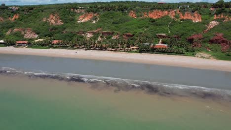 Orbital-Hyperlapse-with-Drone-on-small-paradise-beach-with-green-sea-and-calm-waters-in-northeastern-Brazil