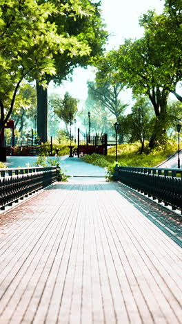 a wooden bridge in a park, with green trees on either side