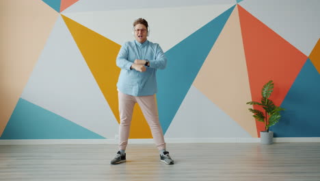 man dancing to music in a colorful room