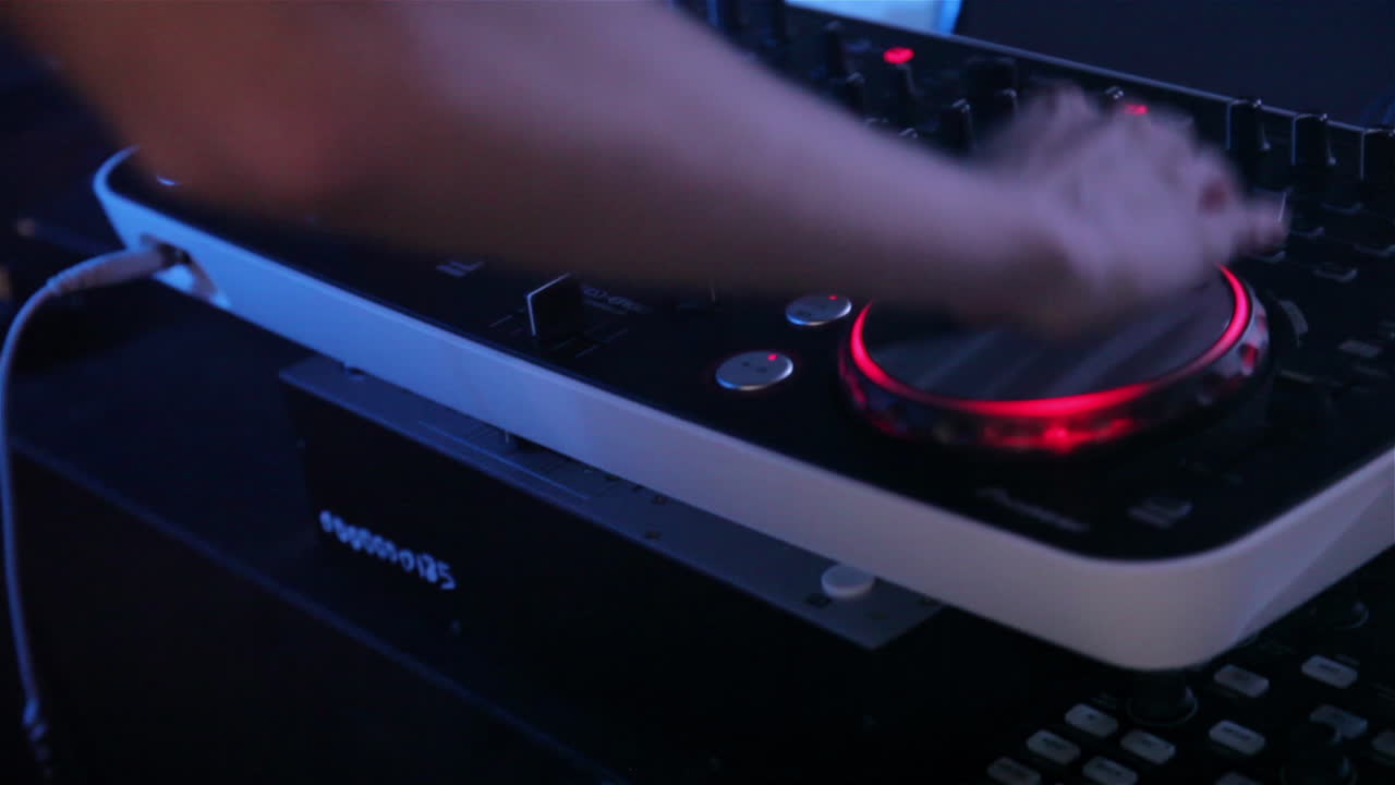 Dj plays on the remote in a nightclub closeup of dj console