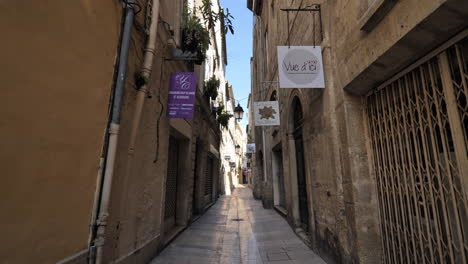 narrow street with closed shops in the town of montpellier during lockdown