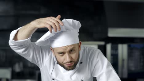 chef man posing at professional kitchen. male chef preparing to cook at kitchen