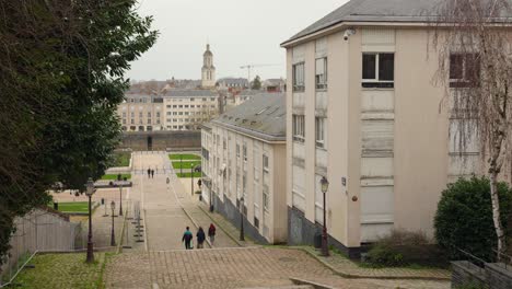 people walking in the montee saint-maurice, popular staircase street in daytime in angers, france