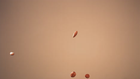 super slow motion shot of cashew nuts pile flying against bright background. shot with high speed video camera, 720 fps