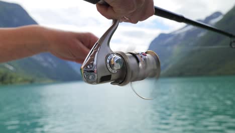 Woman-fishing-on-Fishing-rod-spinning-in-Norway.