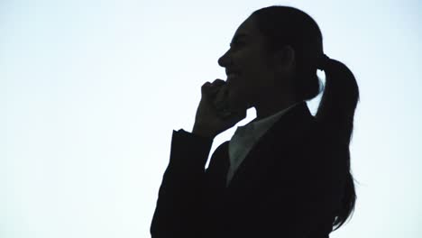 cheerful businesswoman talking by smartphone