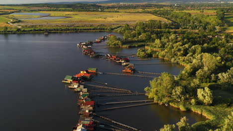 drone shot of the stilt village over the bokodi-hutoto lake in hungary