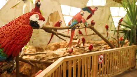 loros vibrantes posados en un aviario exuberante
