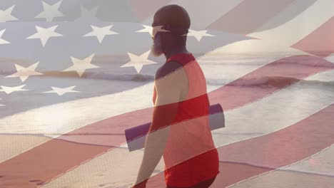 Animation-of-flag-of-usa-over-senior-african-american-man-with-yoga-mat-on-beach