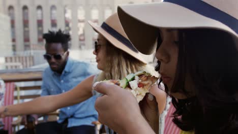 young adult friends hanging out on a rooftop