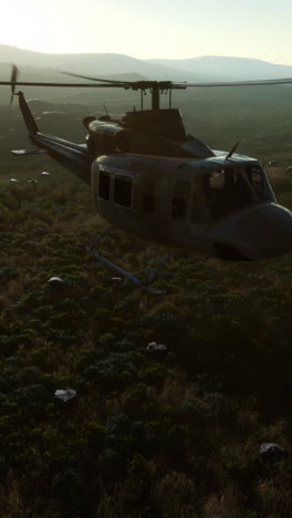 a helicopter flying over a green landscape