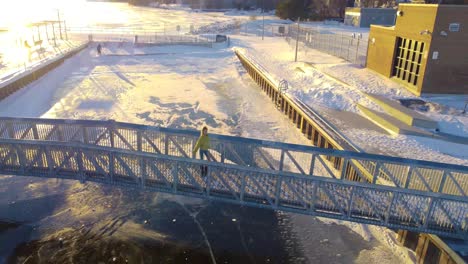 young women enjoying winter sunset on a walking bridge