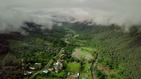 aerial view flying above lush green tropical rain forest mountain with rain cloud cover during the rainy season on the doi phuka mountain reserved national park the northern thailand