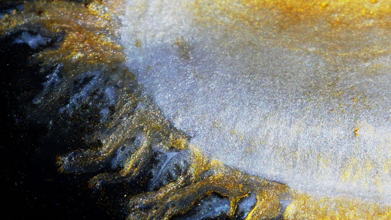 Beautiful yellow Ink in motion creating expanding abstract forms