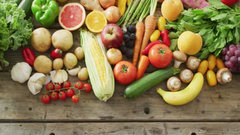 video of fresh fruit and vegetables over wooden background