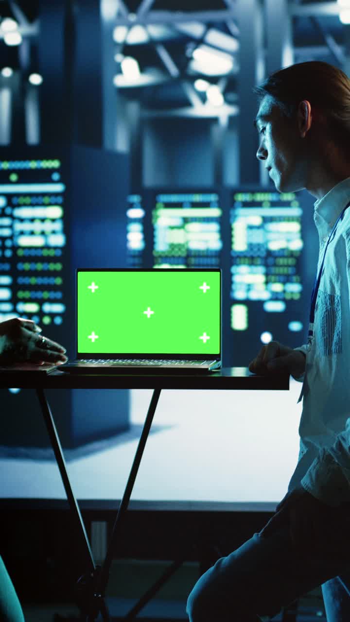 Vertical video Colleagues use chroma key laptop for AI