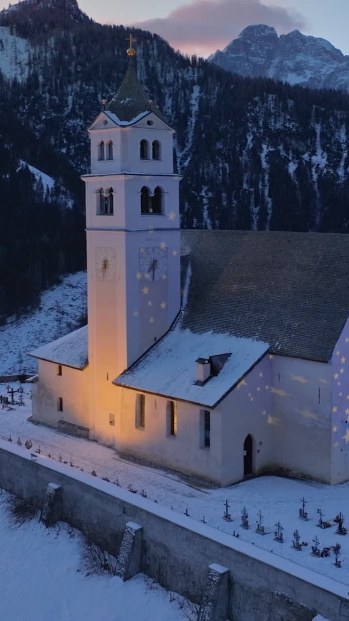 Aerial drone view of the Eglise de Sainte-Lucie in the Colle Santa Lucia comune in Dolomites, Italy. Vertical