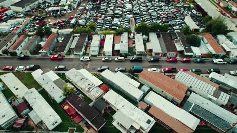 mobile home parking and auto wreck yard full of cars