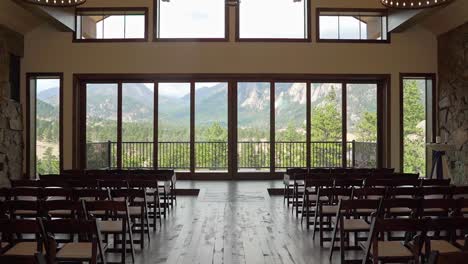 empty indoor wedding venue with panoramic rocky mountains window view