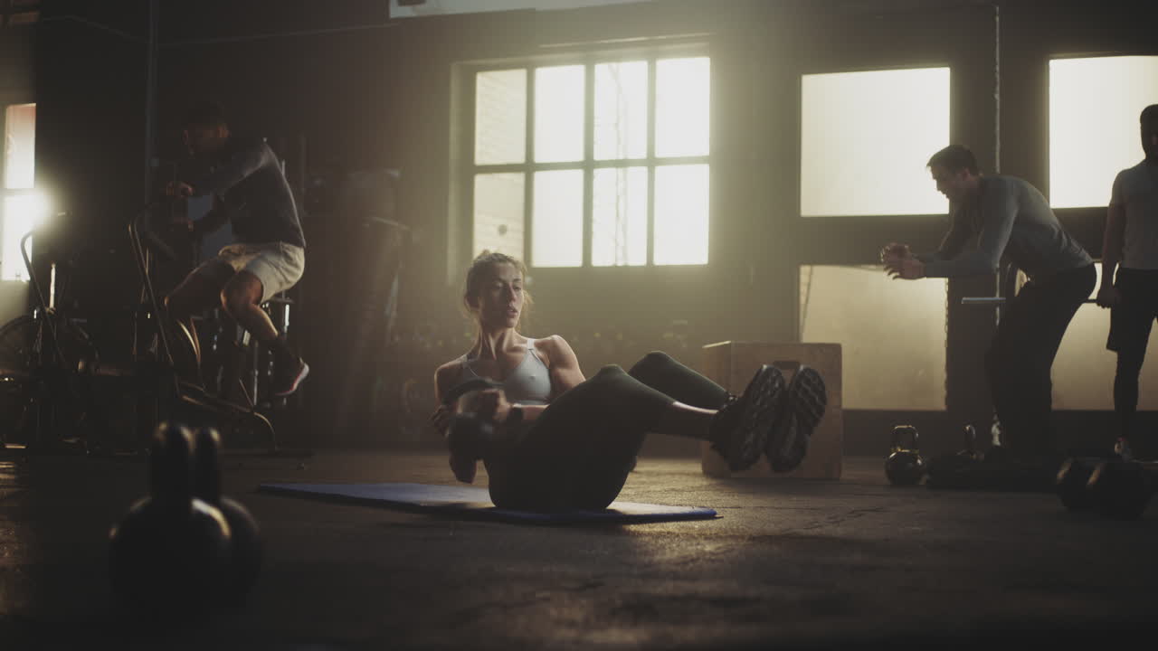 Group Gym Workout with Kettlebell Crunches