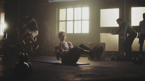 group gym workout with kettlebell crunches