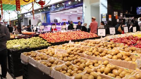 fruit and vegetable stalls with shoppers