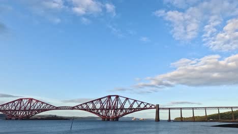 sunset over forth bridge in edinburgh, scotland