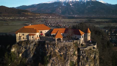 aerial pullback reveals medieval bled castle, slovenia