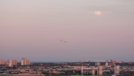 Beautiful-Wide-shot-airplane-approaching-Toronto-International-Airport-by-sunset-lights