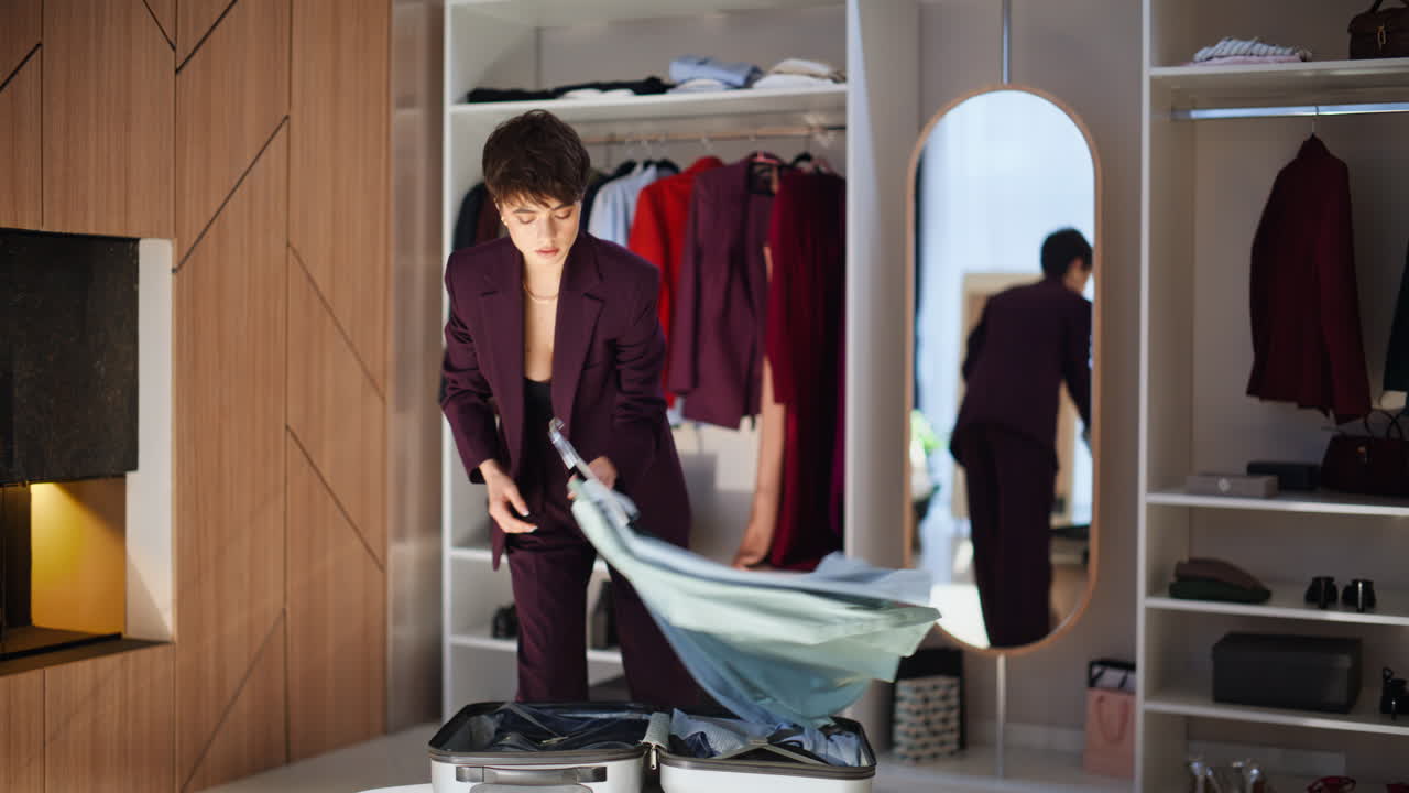 Pensive woman choosing clothes packing luggage preparing business trip solo