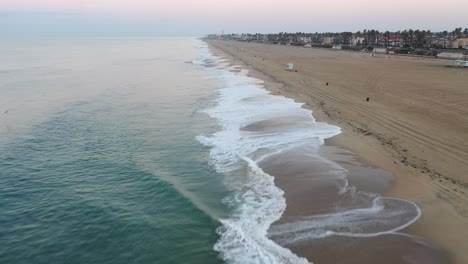 A-stunning-4k-view-of-the-crystal-clear-blue-waters-of-sunny-Surf-City-USA-Southern-California-as-cars-enjoy-the-view-of-the-Pacific-Coast