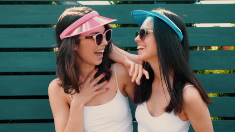 two happy women laughing outdoors