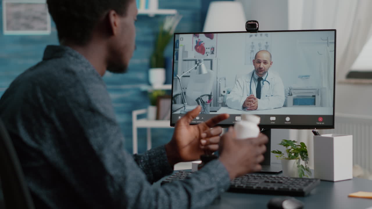Black man at home seeking medical help from doctor