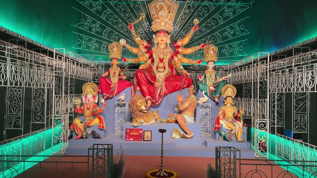 Beautiful goddess Durga at a puja pandal with green color decoration.