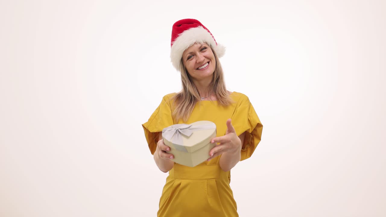 Woman in Santa Hat with Heart-Shaped Gift Box