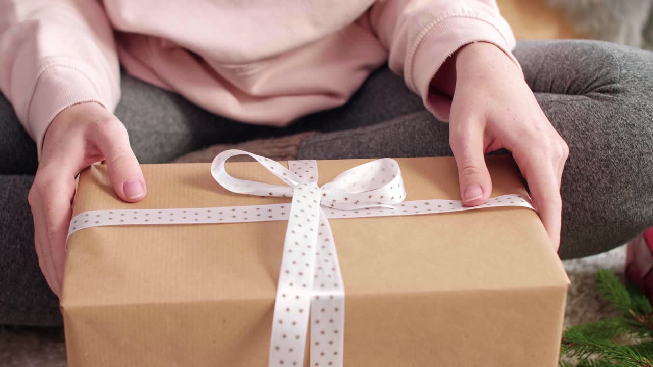 Woman's hands packing the christmas presents