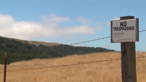 Time lapse of clouds drifting past a no trespassing sign 2