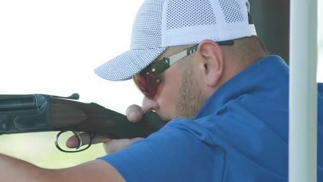 sportsman shoots from a double-barreled shotgun, a sports field for a shooting test is shooting at flying skeet