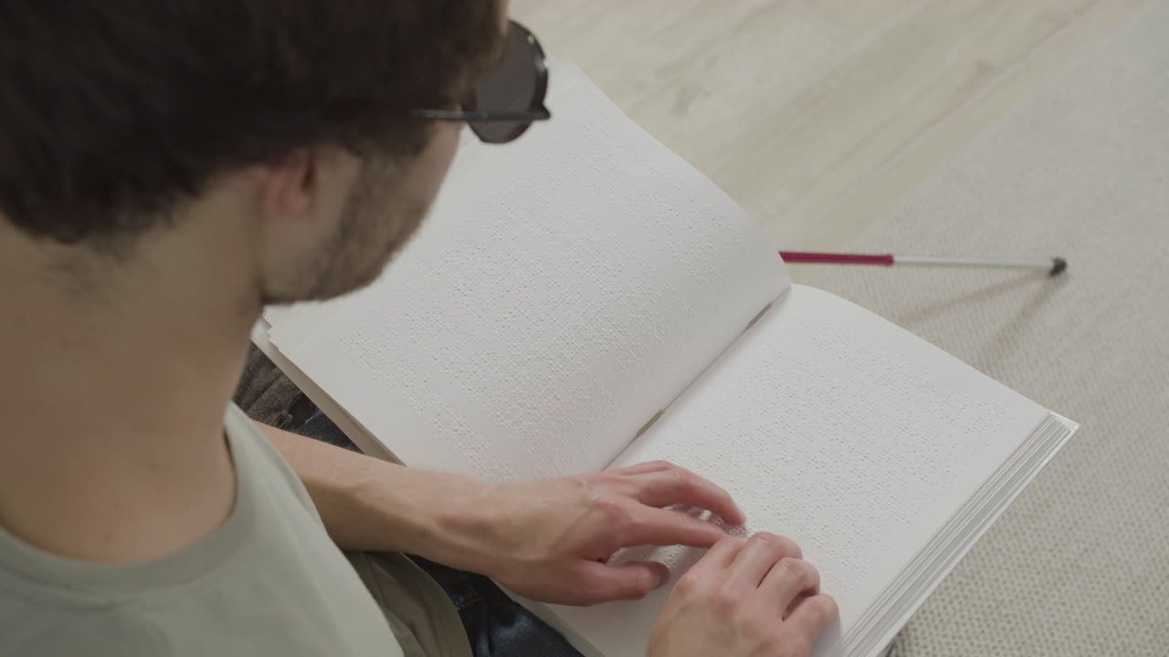 Top view of caucasian young man touching a book