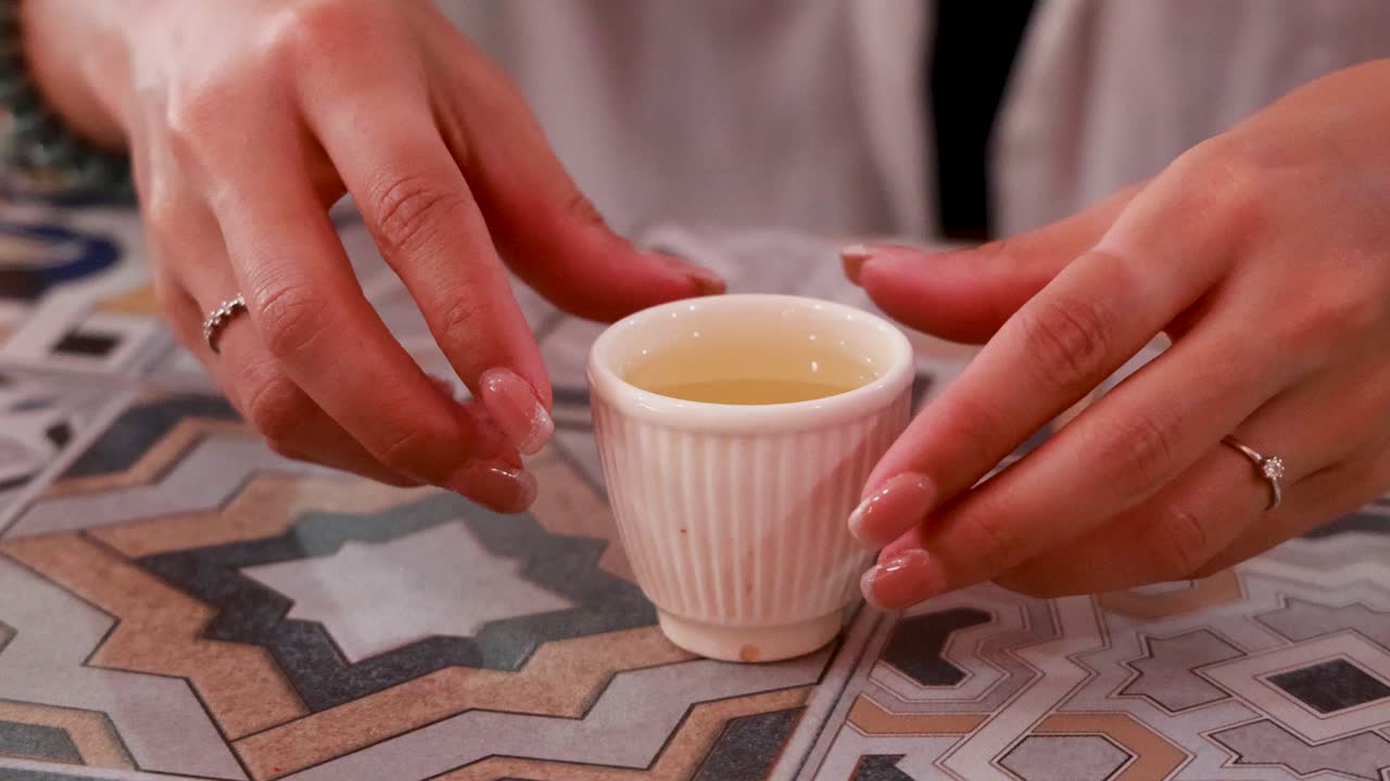 A serene tea ceremony unfolds with delicate hand movements, capturing cultural elegance in a warm, intimate setting