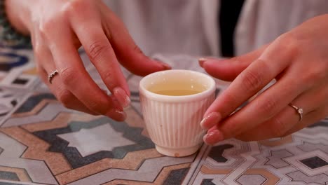 a serene tea ceremony unfolds with delicate hand movements, capturing cultural elegance in a warm, intimate setting