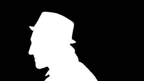 young man puts on hat and walks away, white silhouette on black background