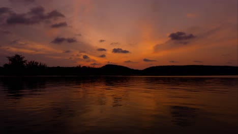 Stunning-sunset-time-lapse-over-the-sea-with-mountain-on-the-background