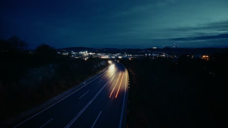 Nighttime-Timelapse-of-cars-passing-by-under-bridge