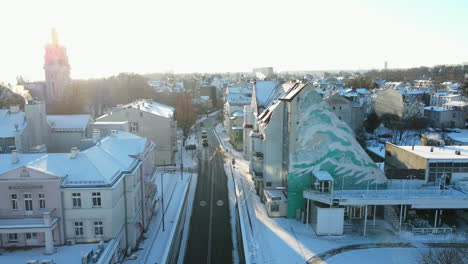 aerial view of beautiful snow covered city of gdansk with driving cars on road during sunrise, poland