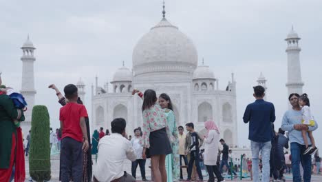 indian people clicking pictures in front of taj mahal