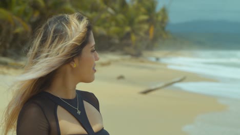 Close-up-of-a-girl-smiling-and-walking-in-the-sand-with-her-hair-blowing-in-the-wind