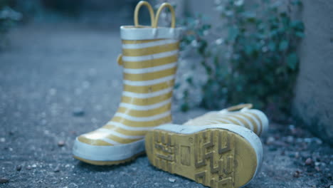 slow pan past some yellow and white striped wellington boots.