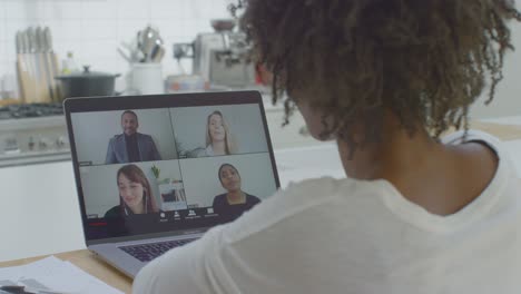 Middle-Aged-Woman-Talking-to-Other-People-During-Laptop-Video-Call